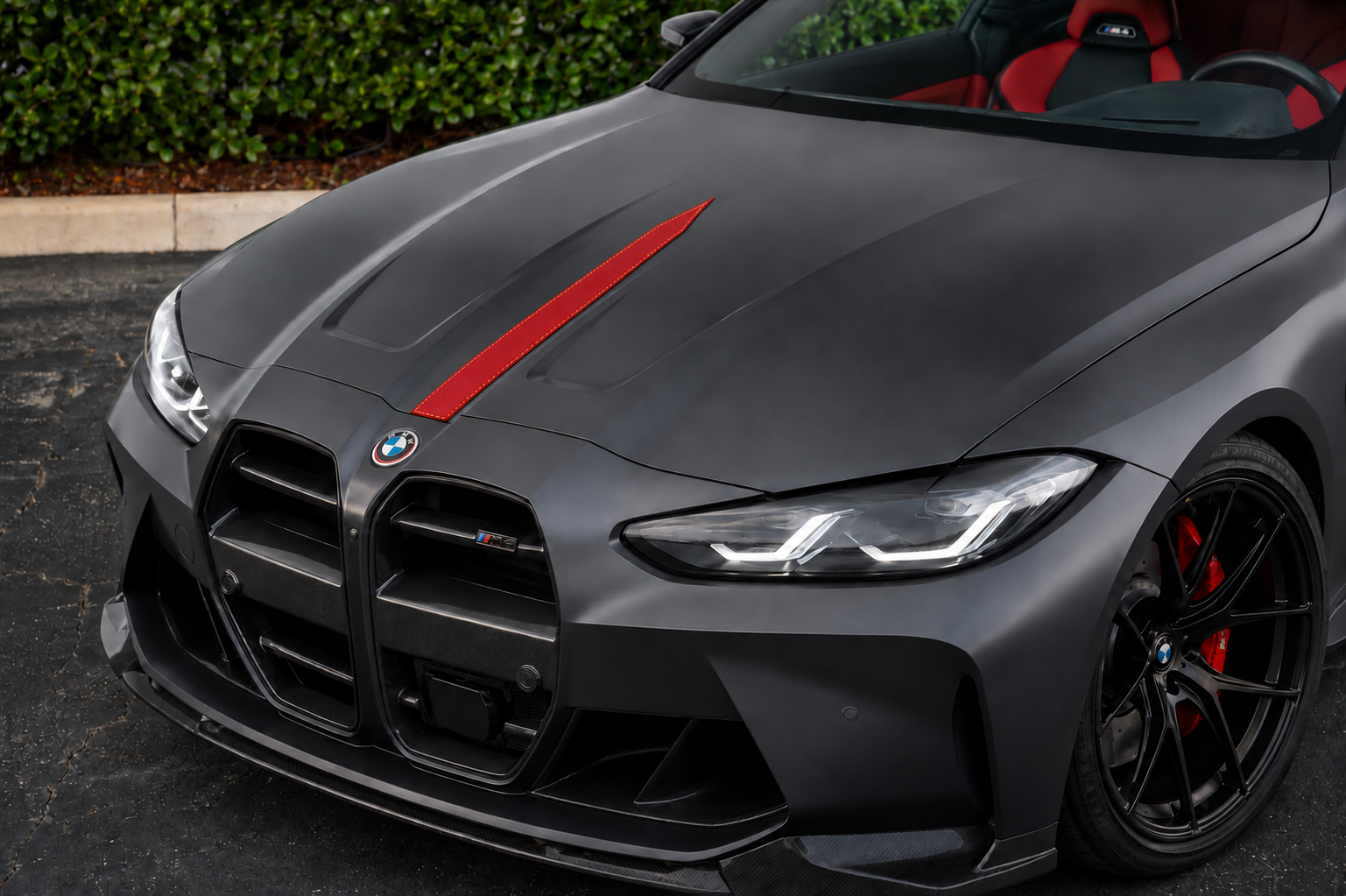 Concept with a narrow red stitched leather stripe on a performance car hood