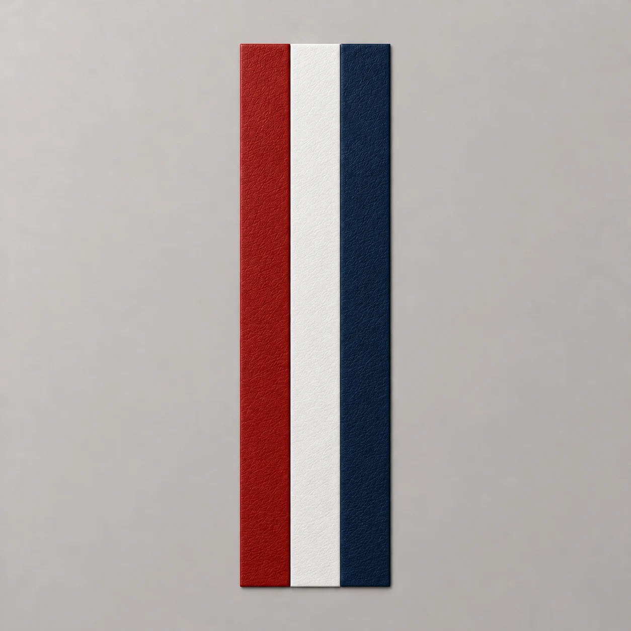 Concept render of red, white and navy blue leather stripes side by side, all without stitching, on a neutral background