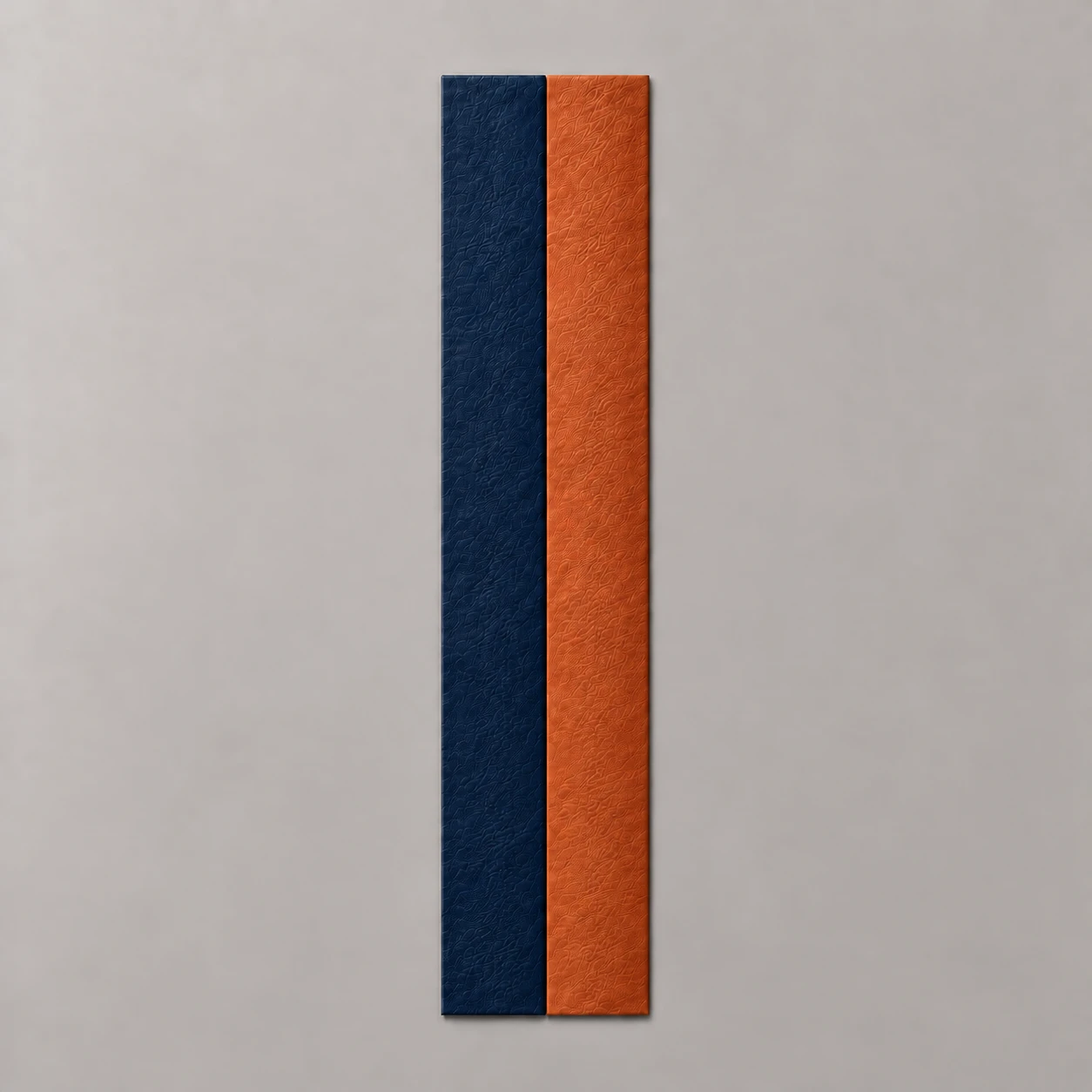 Color study of navy blue and burnt orange leather stripes side by side, both without stitching, on a neutral background